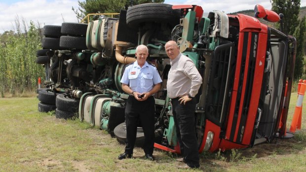 Fire and Rescue NSW Superintendent Kim Reeson and Transport Industries Skills Centre chief executive Ken Brennan near a training vehicle overturned.