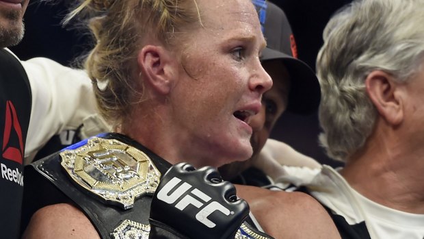 Holly Holm holds the champion belt after her win against Ronda Rousey.