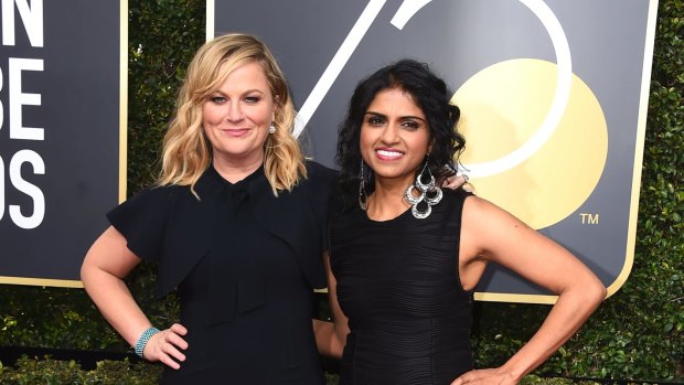 Amy Poehler, left, and Saru Jayaraman arrive at the 75th annual Golden Globe Awards at the Beverly Hilton Hotel on Sunday, Jan. 7, 2018, in Beverly Hills, California.