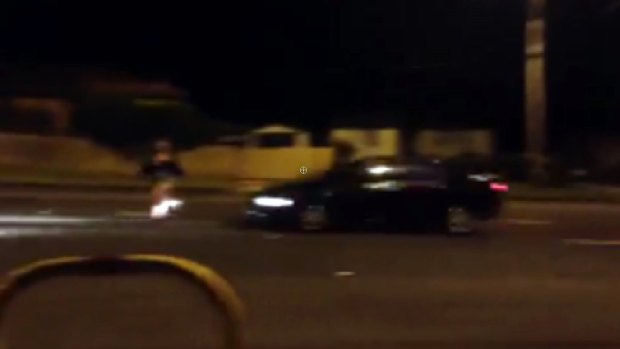 The girl in the road as the car approaches in a screengrab from the video.