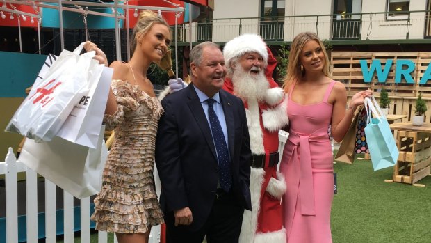 Lord Mayor Robert Doyle with Santa and Ruby (L) and Lucy (R) Brownless at the launch of Shop the City in Melbourne on November 6, 2017.