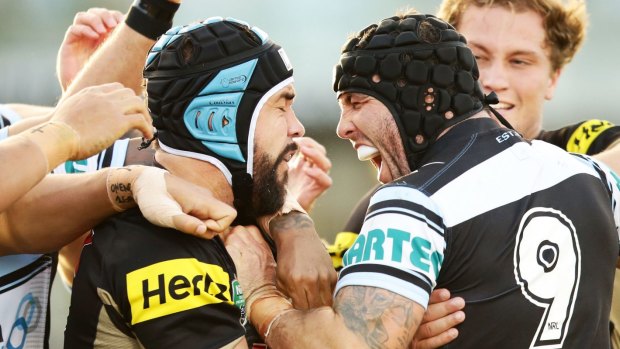 Michael Ennis of the Sharks, right, wrestles with Jamie Soward of the Panthers after the Lewis hit on Moylan.