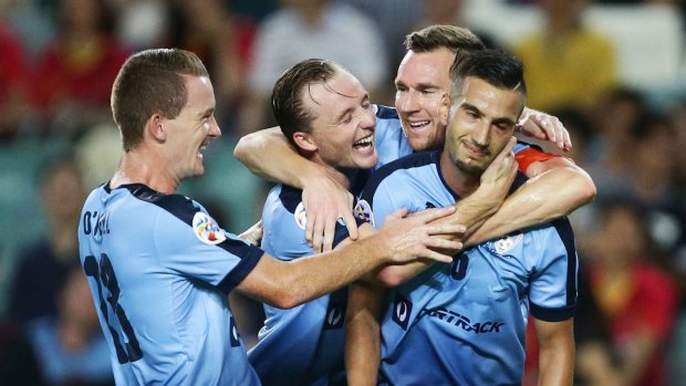 Night to remember:  Robert Stambolziev (right) is mobbed after scoring for Sydney FC against Guangzhou Evergrande.