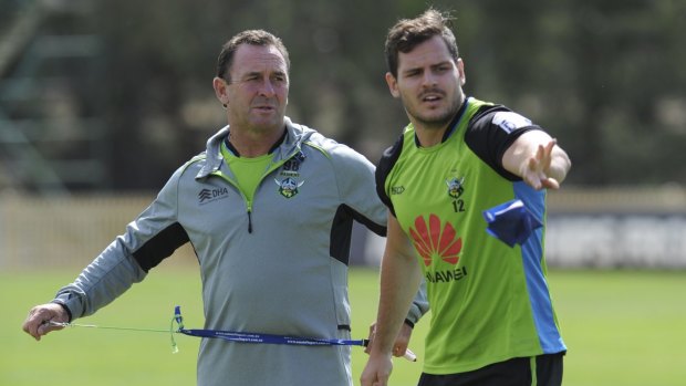 Returning halfback Aidan Sezer chats to Canberra Raiders coach Ricky Stuart at training on Thursday.