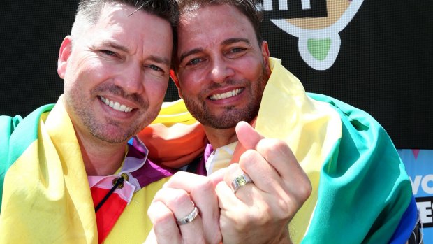 Scott D'Amico and Brad Harker celebrate after the same sex marriage vote result announcement in Queens Park in Brisbane on Wednesday.