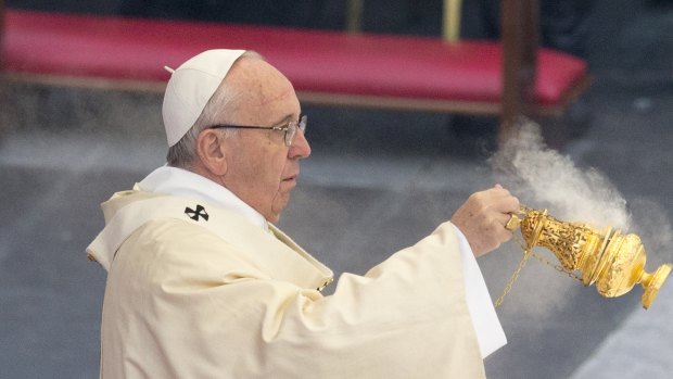 Pope Francis spreads incense during a Mass in St. Peter's Square at the Vatican on Tuesday. 