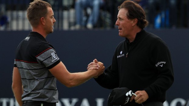 Henrik Stenson celebrates victory on the 18th green with Phil Mickelson.