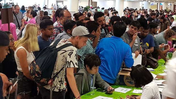 Hundreds of passengers crowd customer service desks at Ngurah Rai International Airport in Denpasar last week.