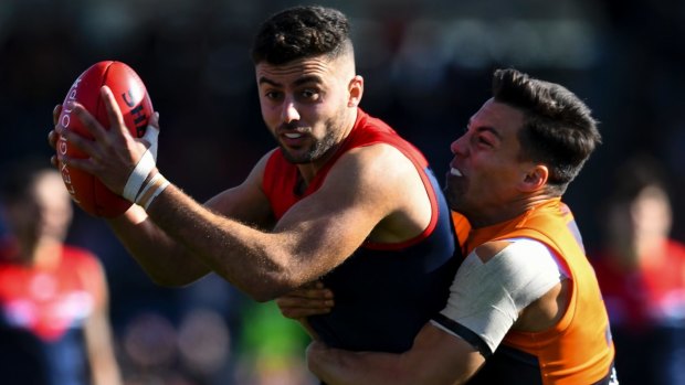 Christian Salem fights for the ball with Dylan Shiel of the Giants.