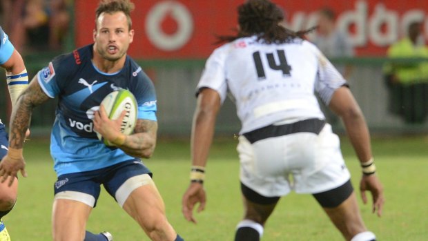 Evasive action: Francois Hougaard of the Bulls takes on the Sharks defence.
