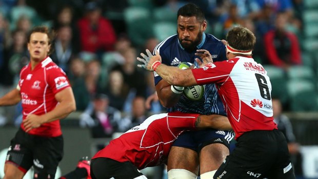 Close quarters: Blues lock Patrick Tuipuluotu makes a charge at the Lions defence.