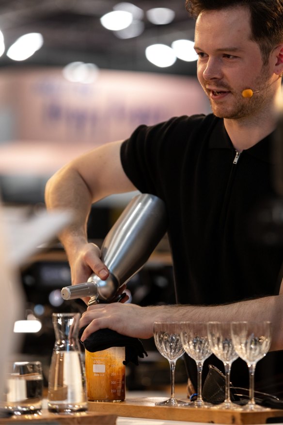 Douglas serves his signature coffee drink  at the 2022 World Coffee Championships.