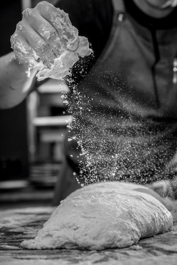 A dusting of semolina helps prevent the dough from sticking to the bench.