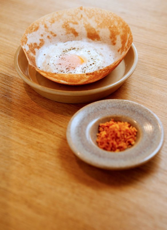 An egg hopper with sambal.