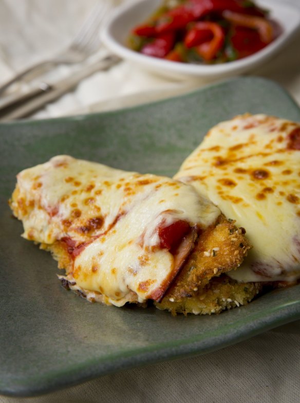 Chicken parmigiana with roast capsicum and tomato salad. 