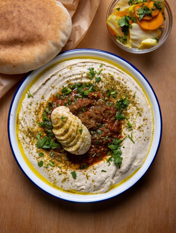 Humshuka (hummus with shakshuka sauce and hard-boiled egg.