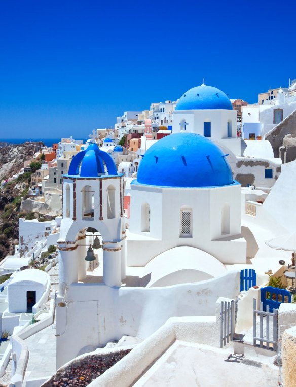 A church with blue domes in the village of Oia, Santorini.