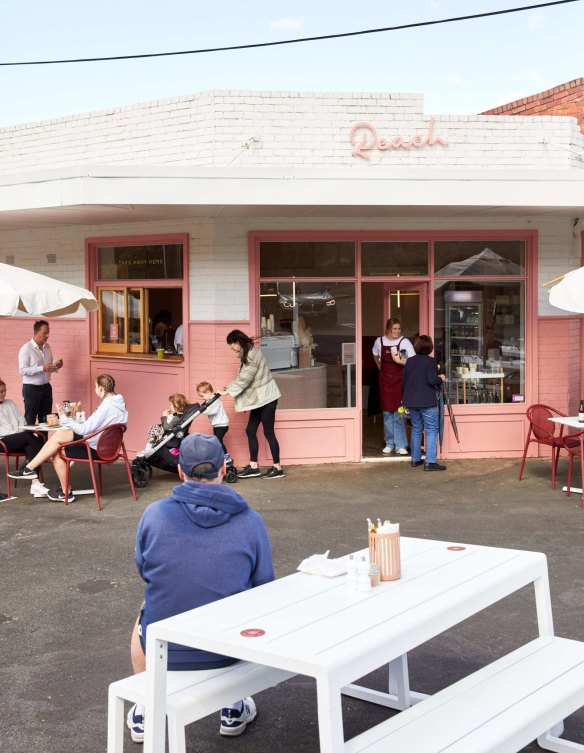 The corner cafe's peachy colour scheme and takeaway window.