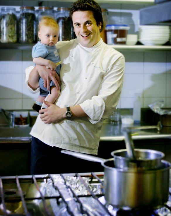 Chef, Darren Simpson with his son Angus, 2 months, in the kitchen of Aqua Luna in 2003.