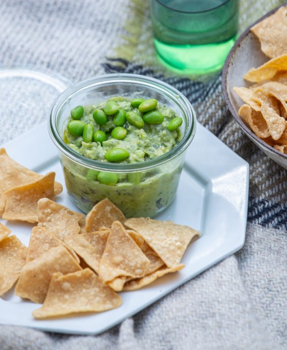 Avocado and edamame dip with tortilla chips.