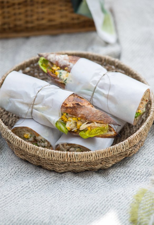 Chicken and corn baguettes, wrapped and packed for a picnic.