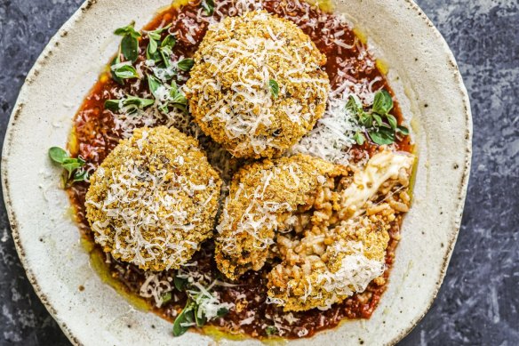 Cheesy bolognese arancini in tomato sauce.