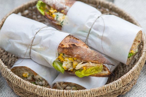 Chicken and corn baguettes, wrapped and packed for a picnic.