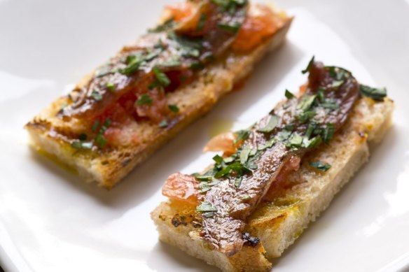 Anchovy with tomato and garlic on grilled bread.