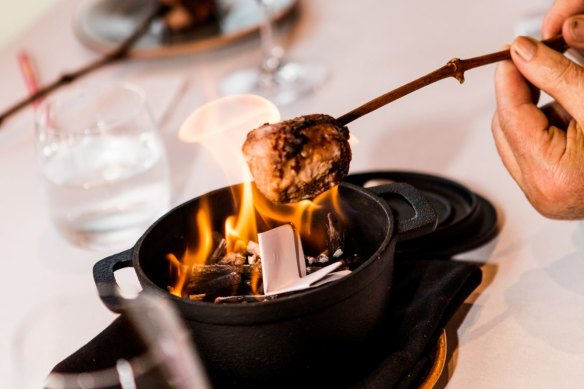 Chocolate marshmallows toasted over an at-table bonfire.