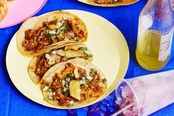 Tacos al pastor are served in double tortillas with finely chopped onion and coriander, freshly squeezed lime juice and spicy salsa.
