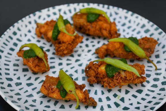 Deep-fried chicken ribs with chimichurri and guindilla peppers.