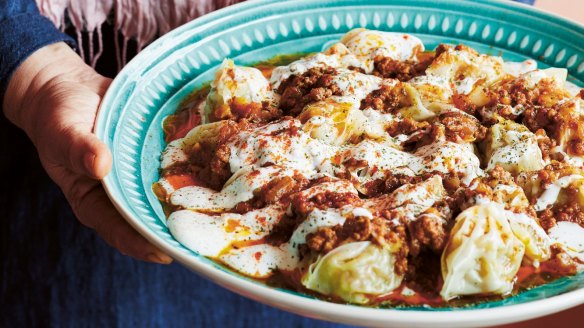 Mantu is finished with a generous drizzle of garlic-yoghurt dressing, and a sprinkling of dried mint and paprika.