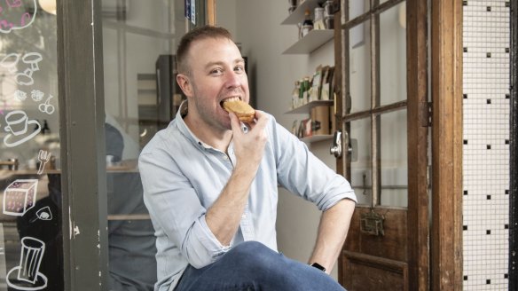 Tokyo Lamington co-owner Eddie Stewart tries a coffee chocolate eclair in Newtown.