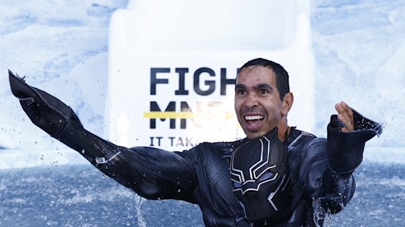 Eddie Betts, former Carlton and Adelaide player, goes down the slide for Big FightMND Freeze 8, as The Blank Panther. 