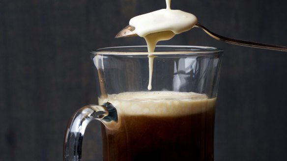 Carefully add the cream to the top of the Irish coffee.