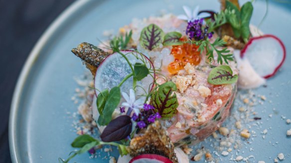 Buxton trout tartare with smoked trout mousse, citrus pearls and hazelnut.