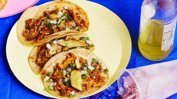 Tacos al pastor are served in double tortillas with finely chopped onion and coriander, freshly squeezed lime juice and spicy salsa.