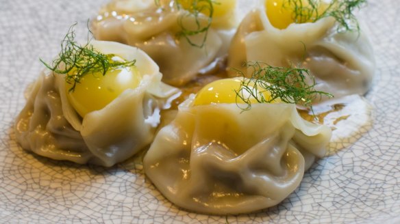 Luxe crab gyoza each capped with a quail egg yolk.  