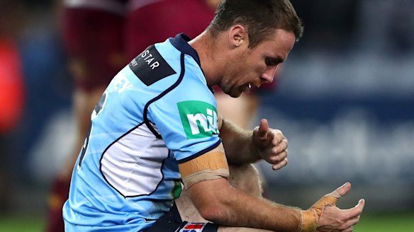 Gutted: James Maloney crouches over in dejection after the final whistle.