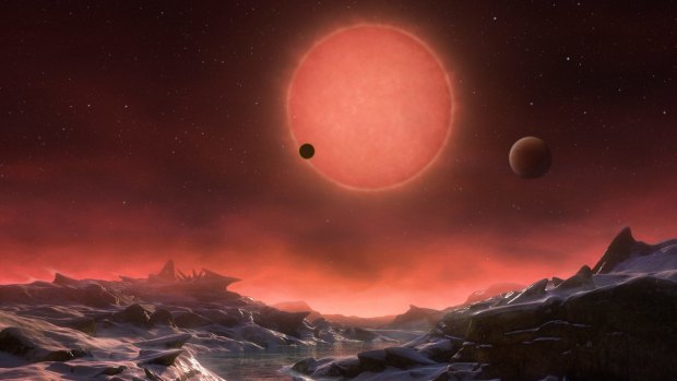 An artist's impression shows an imagined view from the surface one of the three planets orbiting an ultracool dwarf star just 40 light-years from Earth.