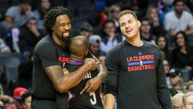 Mighty effort: Clippers guard Chris Paul, center, celebrates with teammates DeAndre Jordan, left, and forward Blake Griffin.