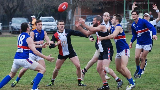 All in: Saints coach Luke Morgan (long sleeves) in the middle of proceedings against Tatura last year.