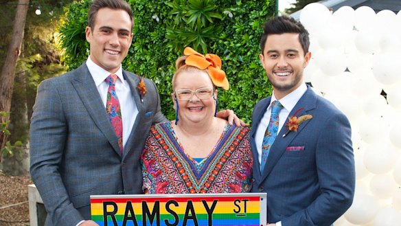 Rainbow over Ramsay Street: Magda Szubanski (Jemima Davies-Smythe) helps Matt Wilson (left, Aaron Brennan) and Tayaka Honda (David Tanaka) tie the knot.  