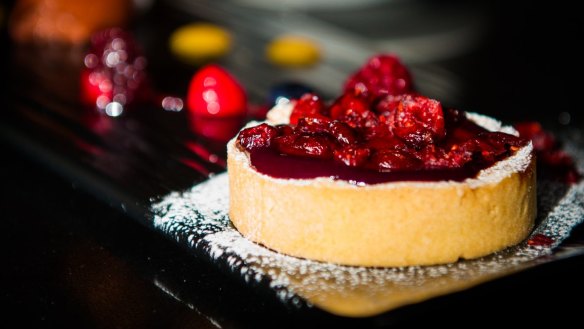 Cranberry tart with dark chocolate mousse, wild berries and chocolate tuille