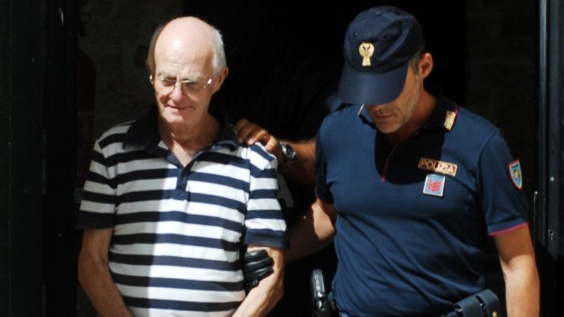 An Italian police officer takes in custody Ugo Di Leonardo,another of the 11 men suspected of helping Denaro.