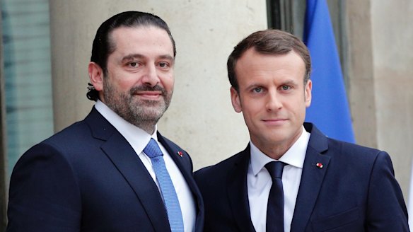 French President Emmanuel Macron greets Lebanon's Prime Minister Saad Hariri in Paris.
