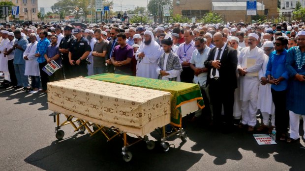 Thousands gather to pray at caskets of Imam Maulama Akonjee, draped in green top, and Thara Uddin.