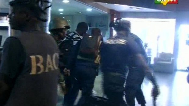 Security forces help hostages to safety, inside the Radisson Blu Hotel in Bamako. This image was taken from Mali TV ORTM.