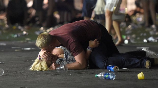 People lie on the ground at a country music festival in Las Vegas after a shots were fired at the concert on Sunday.