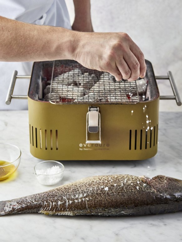 Brush the skin of the body and head with a little oil, then season the fish liberally before placing it on the grill.